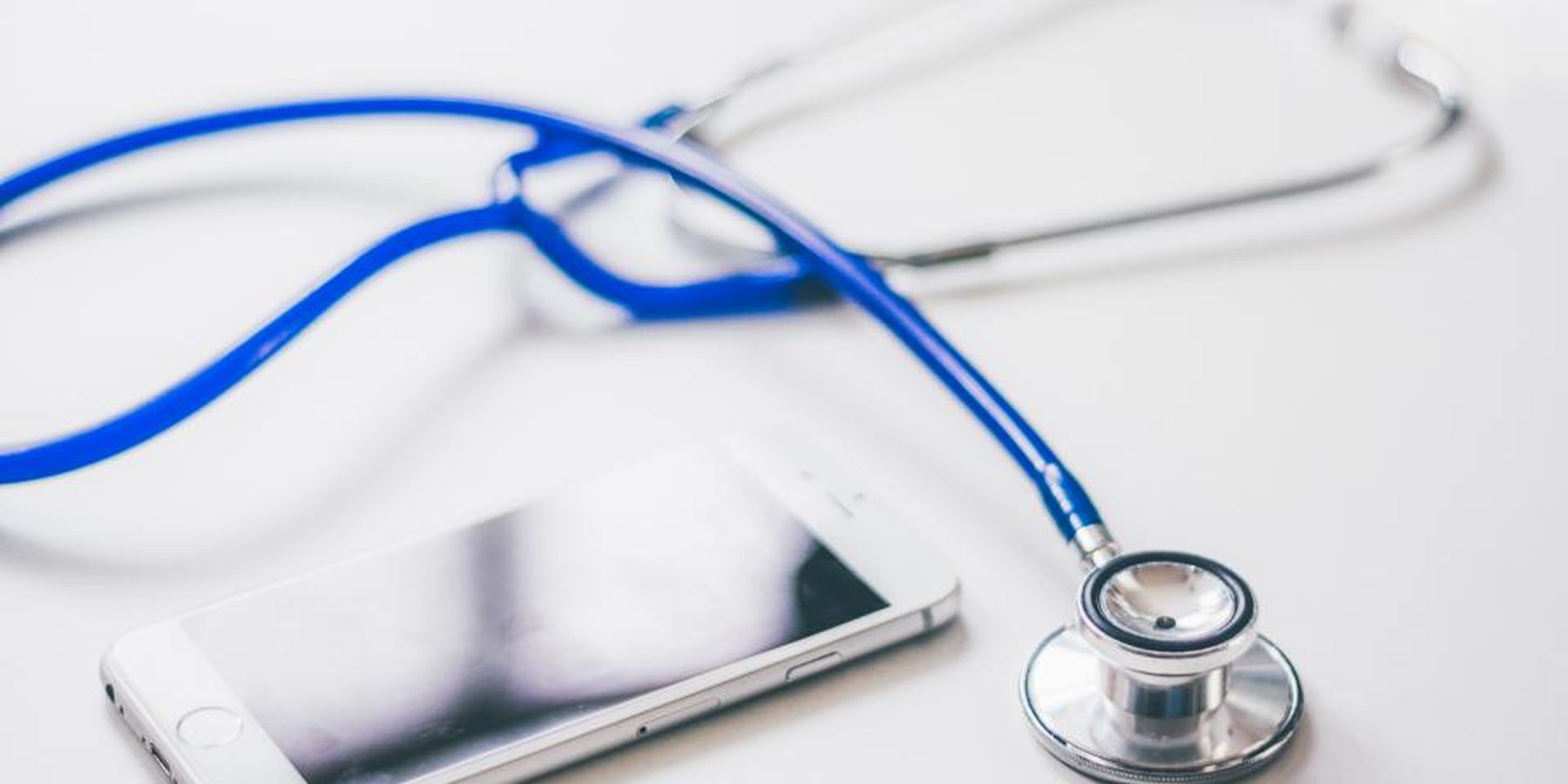 A stethoscope and phone on a desk
