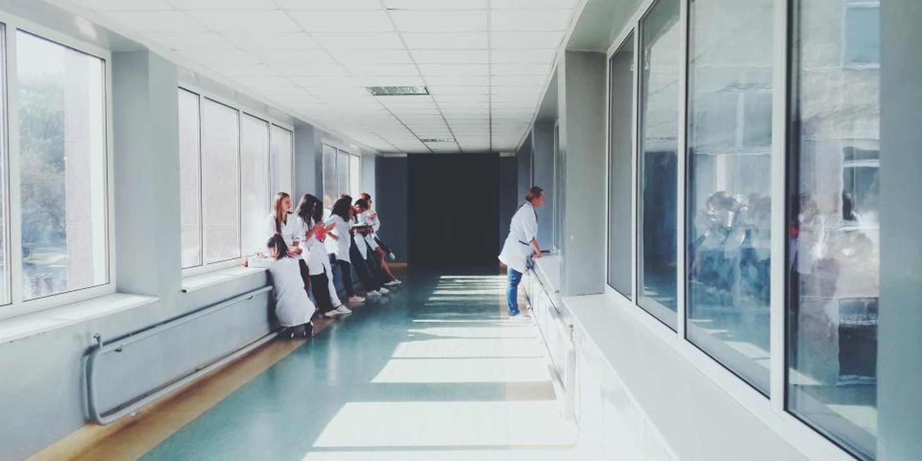 Nurses and clinicians in a bright hospital corridor
